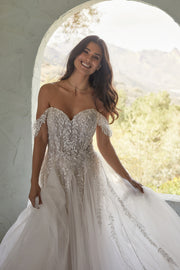 Richly beaded lace appliqués create a tapestry of texture across Karen’s bodice and off shoulder sleeves.