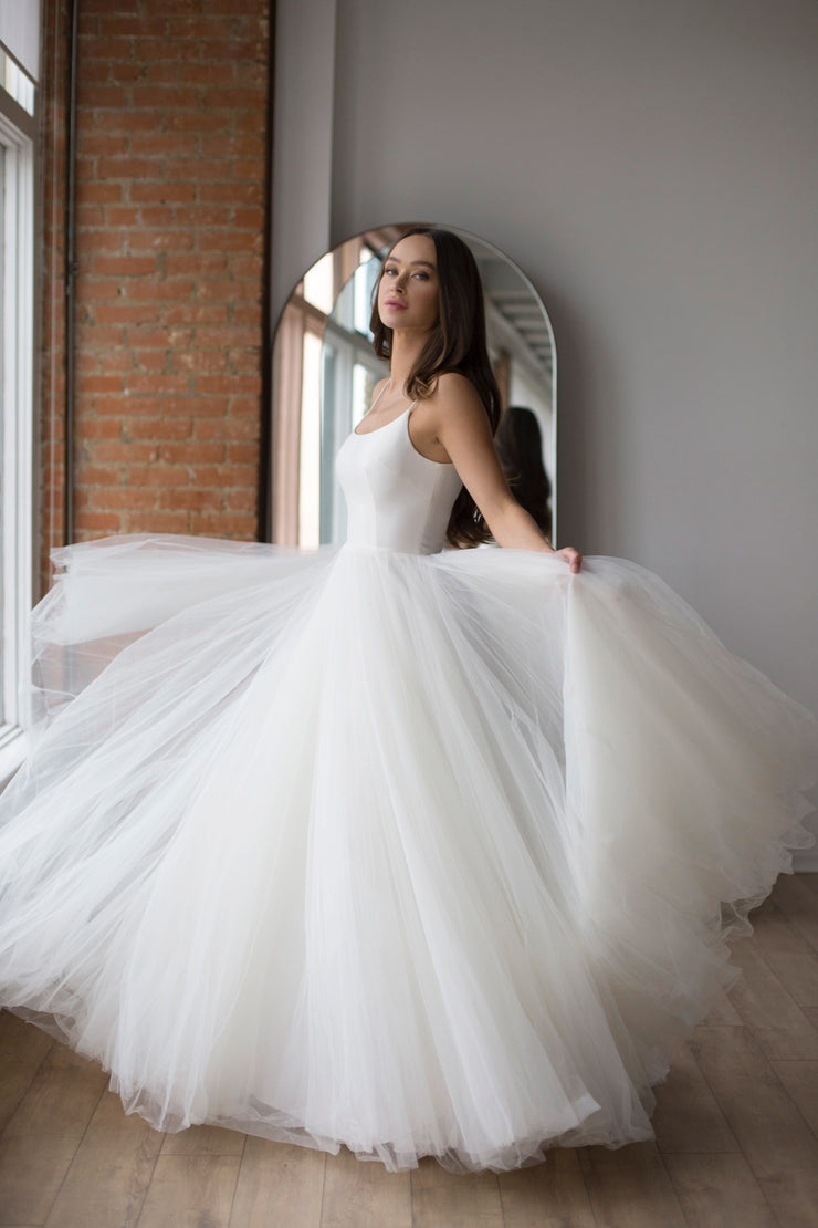 Wtoo Gigi by Watters We’ve mixed our Mikado and Soft net tulle for a perfectly ethereal juxtaposition, structured and relaxed. Gigi’s supportive yet delicate ballet neck is paired with a soft, easy A-line skirt to create a classic bridal look.